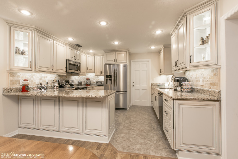 Photo of a mid-sized traditional u-shaped kitchen pantry in Orlando with an undermount sink, raised-panel cabinets, beige cabinets, granite benchtops, multi-coloured splashback, stone tile splashback, porcelain floors, no island and beige floor.