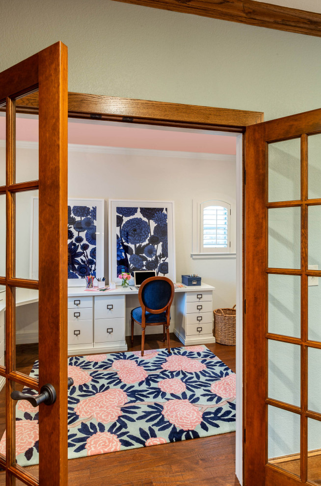 Photo of a mid-sized transitional gender-neutral kids' playroom for kids 4-10 years old in Dallas with white walls, light hardwood floors and brown floor.