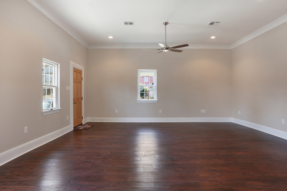 Photo of a large arts and crafts open concept living room in New Orleans with beige walls and dark hardwood floors.