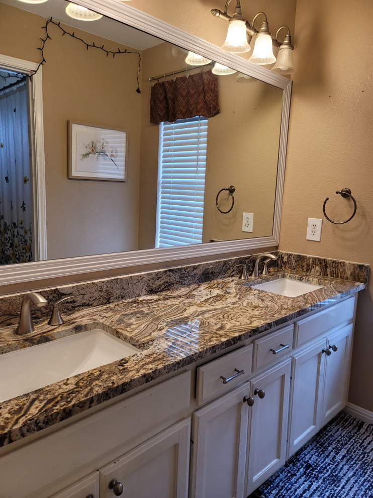 Inspiration for a mid-sized 1960s kids' double-sink bathroom remodel in Austin with recessed-panel cabinets, beige cabinets, granite countertops, brown countertops and a built-in vanity