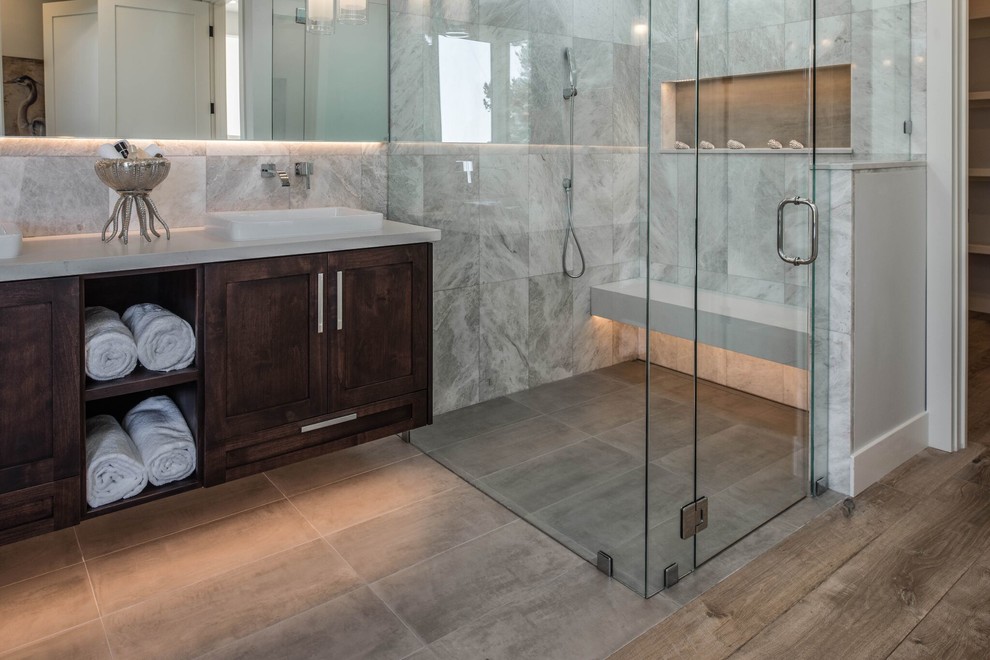 Inspiration for a large transitional master porcelain tile porcelain tile freestanding bathtub remodel in Orange County with shaker cabinets, dark wood cabinets, gray walls and a vessel sink