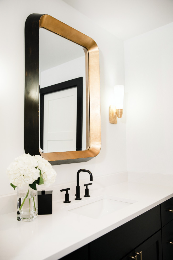 This is an example of a mid-sized transitional 3/4 bathroom in Austin with flat-panel cabinets, black cabinets, a one-piece toilet, black tile, porcelain tile, white walls, cement tiles, a drop-in sink, engineered quartz benchtops, multi-coloured floor, a hinged shower door and white benchtops.