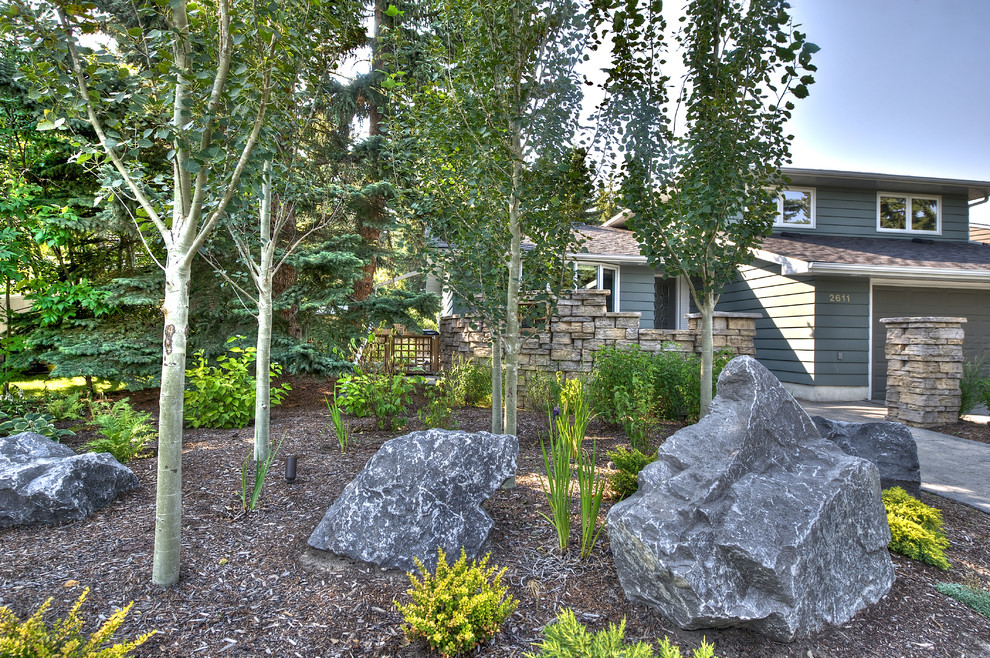 This is an example of a mid-sized traditional front yard garden in Calgary.