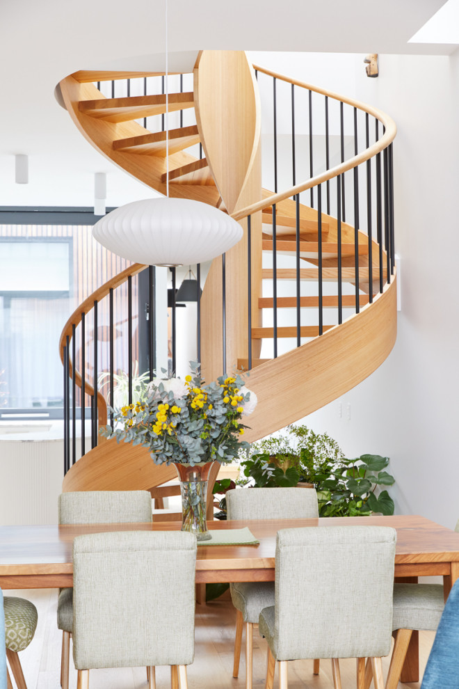 Photo of a mid-sized contemporary wood spiral staircase in Melbourne with open risers and wood railing.