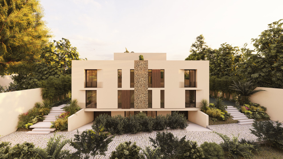 Photo of a contemporary three-storey beige townhouse exterior in Alicante-Costa Blanca with stone veneer.