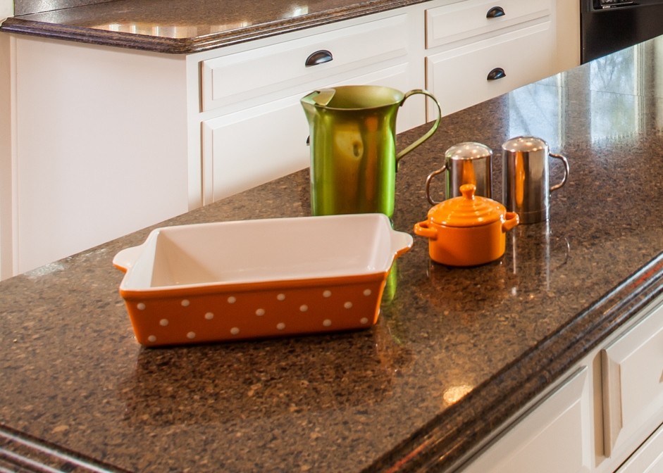 Example of a large transitional u-shaped marble floor eat-in kitchen design in Houston with a drop-in sink, recessed-panel cabinets, white cabinets, granite countertops, brown backsplash, stone tile backsplash, black appliances and an island
