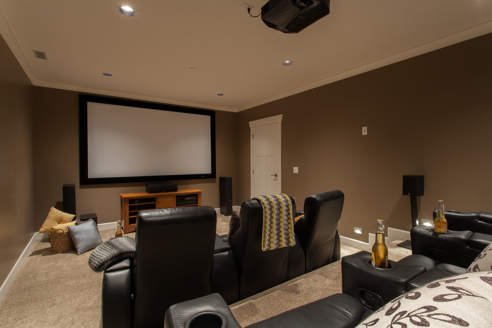 This is an example of a mid-sized arts and crafts enclosed home theatre in Vancouver with brown walls, carpet and a projector screen.