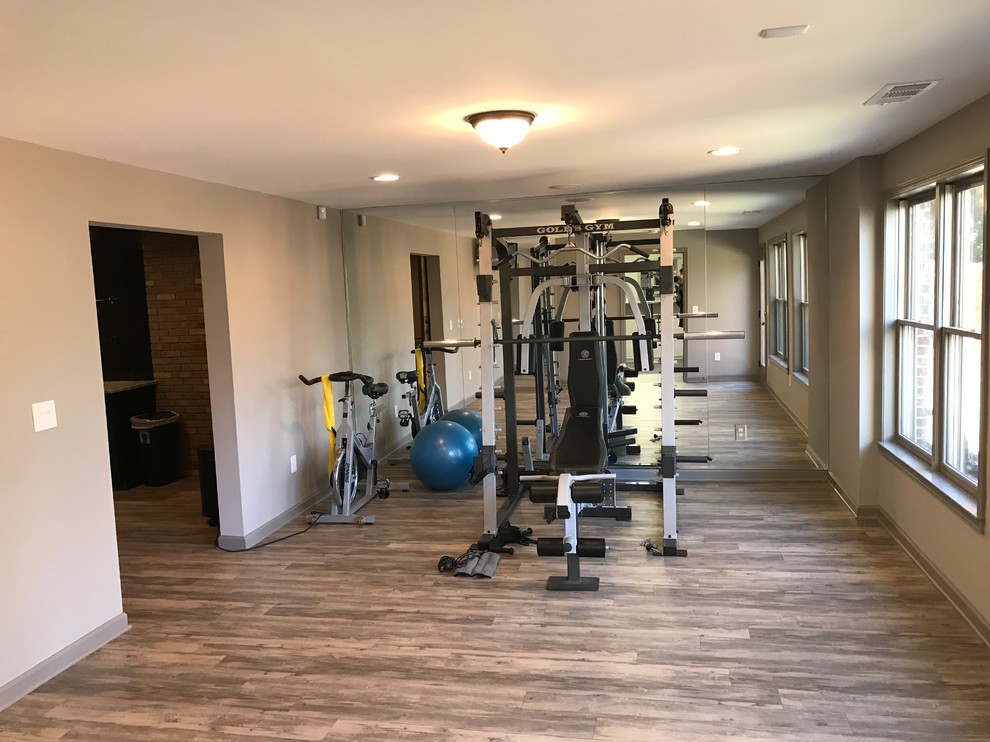 Design ideas for a mid-sized traditional home weight room in Atlanta with white walls and medium hardwood floors.