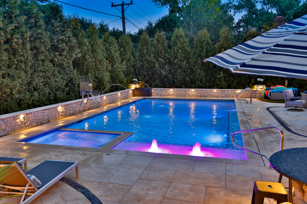 This is an example of a medium sized classic back private and rectangular lengths swimming pool in Chicago with natural stone paving.