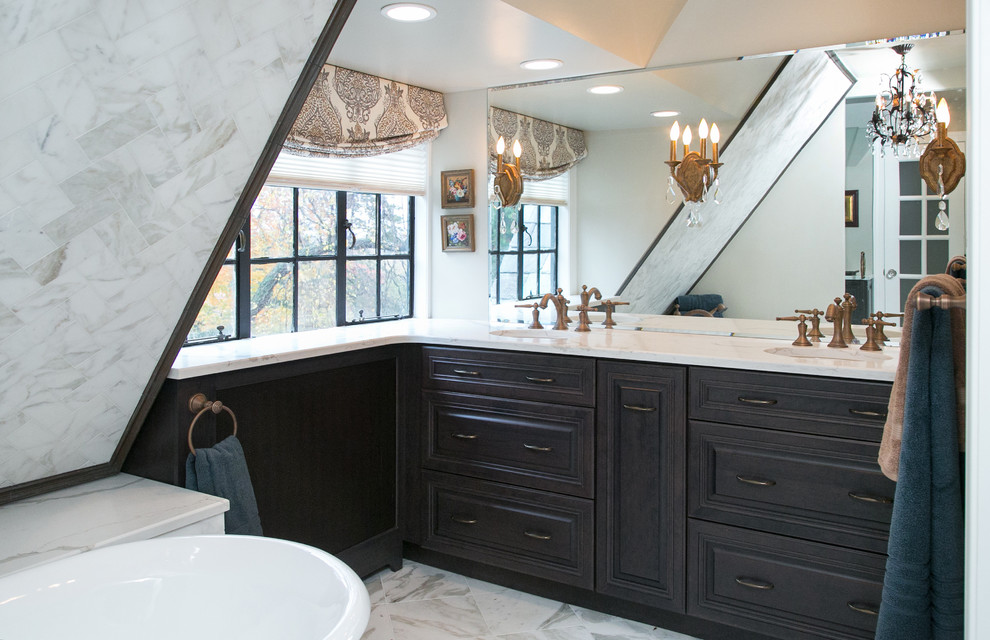 Mid-sized traditional master bathroom in Philadelphia with an undermount sink, raised-panel cabinets, dark wood cabinets, marble benchtops, a claw-foot tub, an alcove shower, a two-piece toilet, white tile, stone tile, grey walls and marble floors.