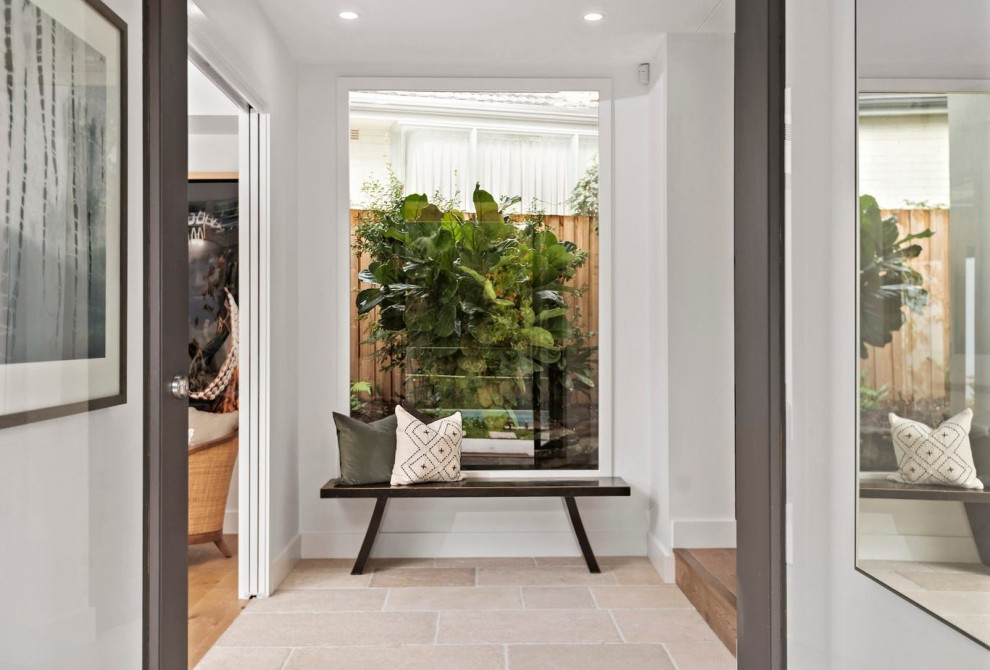 Photo of a contemporary foyer in Sydney with white walls, travertine floors, a double front door and a glass front door.