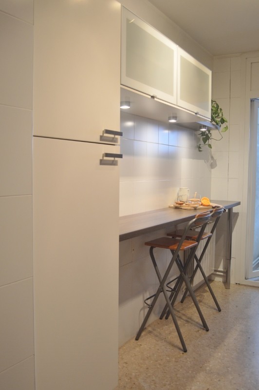Small contemporary single-wall kitchen pantry in Barcelona with flat-panel cabinets, white cabinets, laminate benchtops, white splashback, ceramic splashback, terrazzo floors and no island.