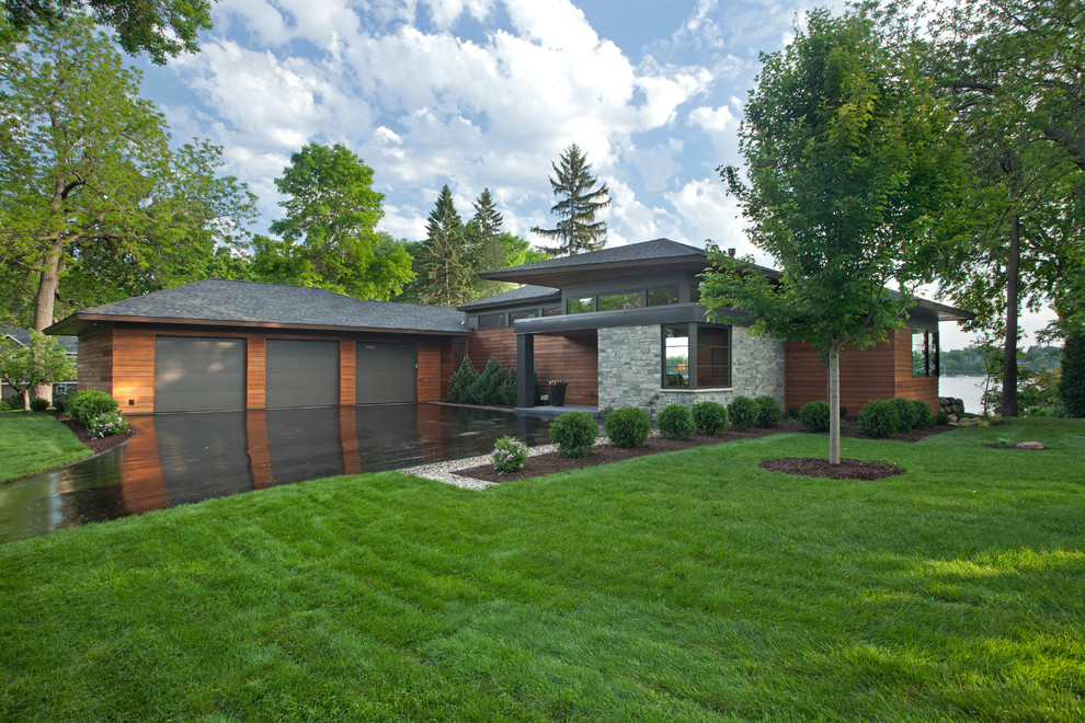 Photo of a contemporary exterior in Minneapolis with wood siding and a hip roof.