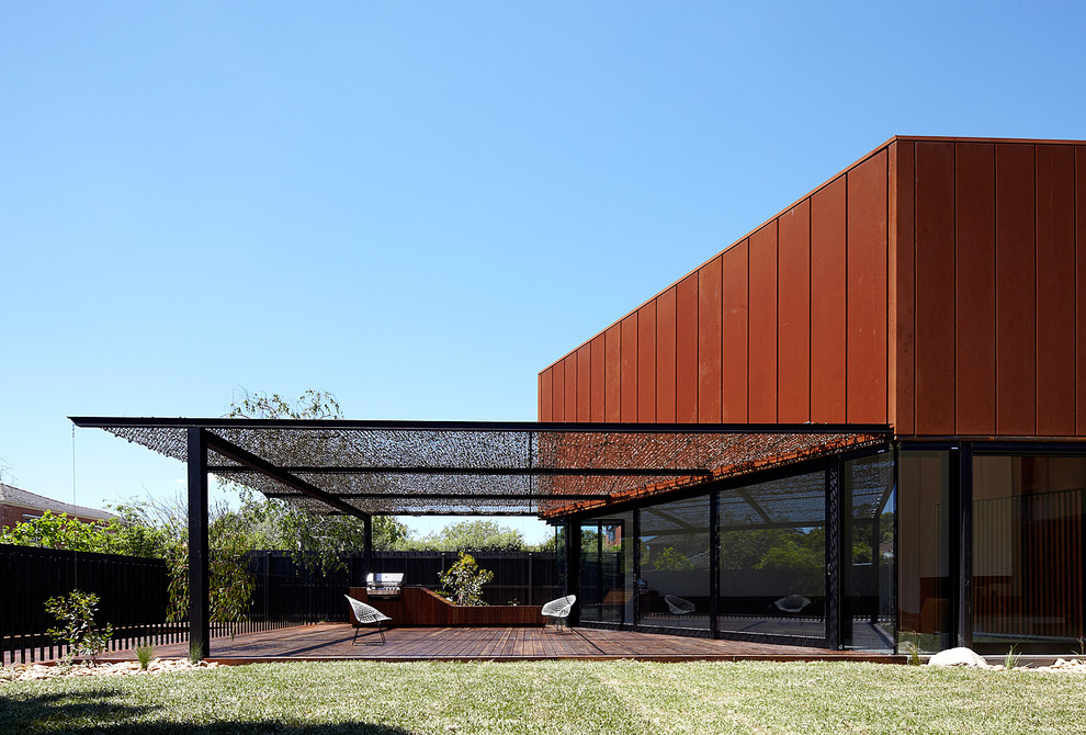 This is an example of a large contemporary deck in Melbourne with a pergola.