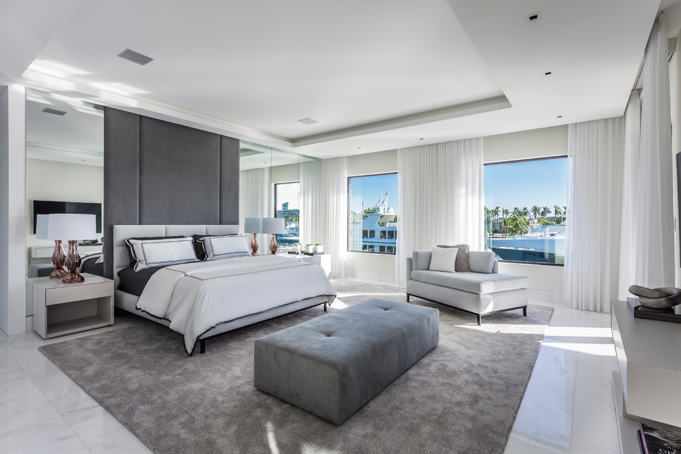 Photo of a contemporary bedroom in Miami with white walls and white floor.