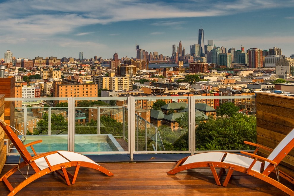 Photo of a modern rooftop deck with no cover.