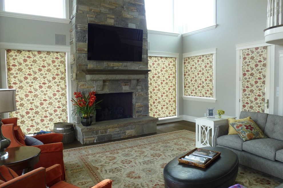 This is an example of a mid-sized transitional formal open concept living room in Salt Lake City with grey walls, medium hardwood floors, a standard fireplace, a stone fireplace surround, a wall-mounted tv and brown floor.
