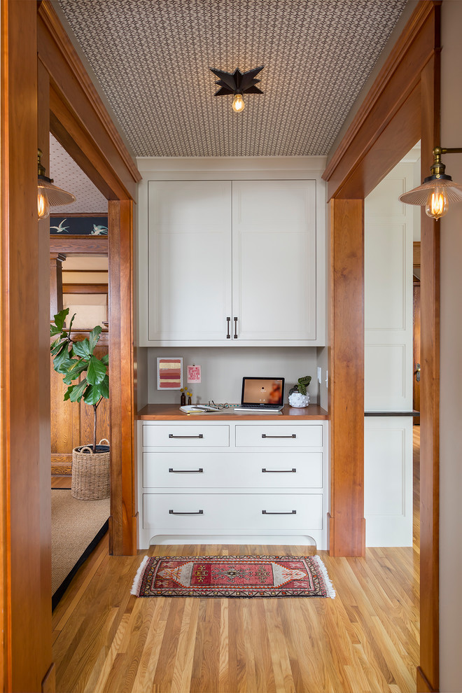 This is an example of a small traditional mudroom in Minneapolis with light hardwood floors.