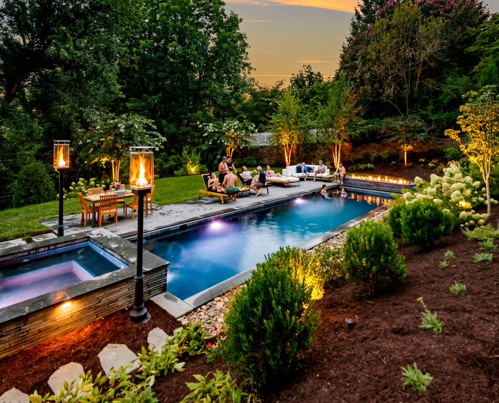Backyard stone and rectangular hot tub photo