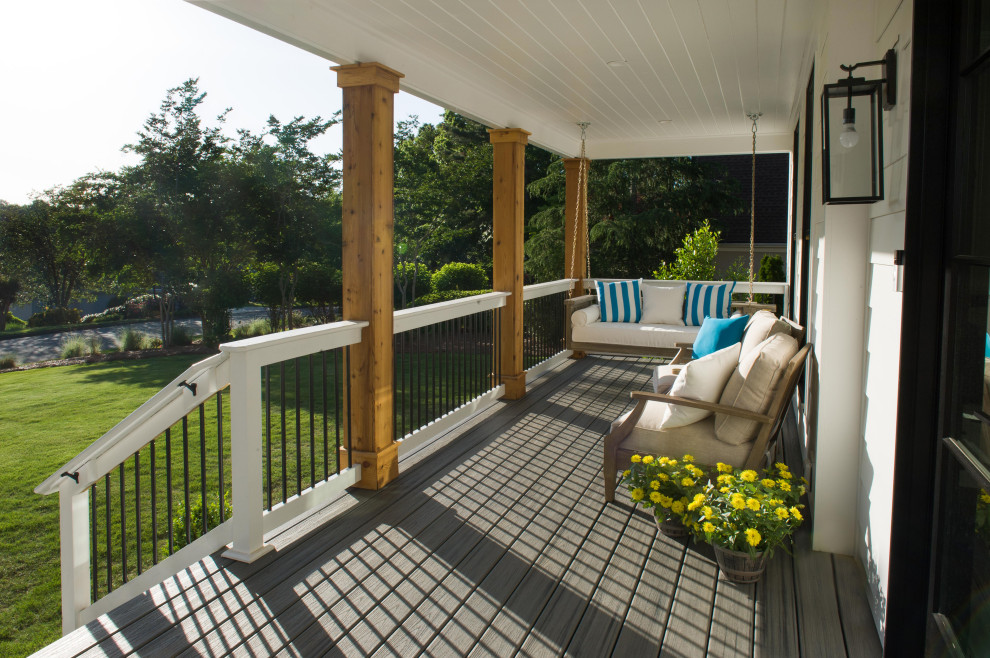 This is an example of a large rural front mixed railing veranda in Atlanta with decking and a roof extension.