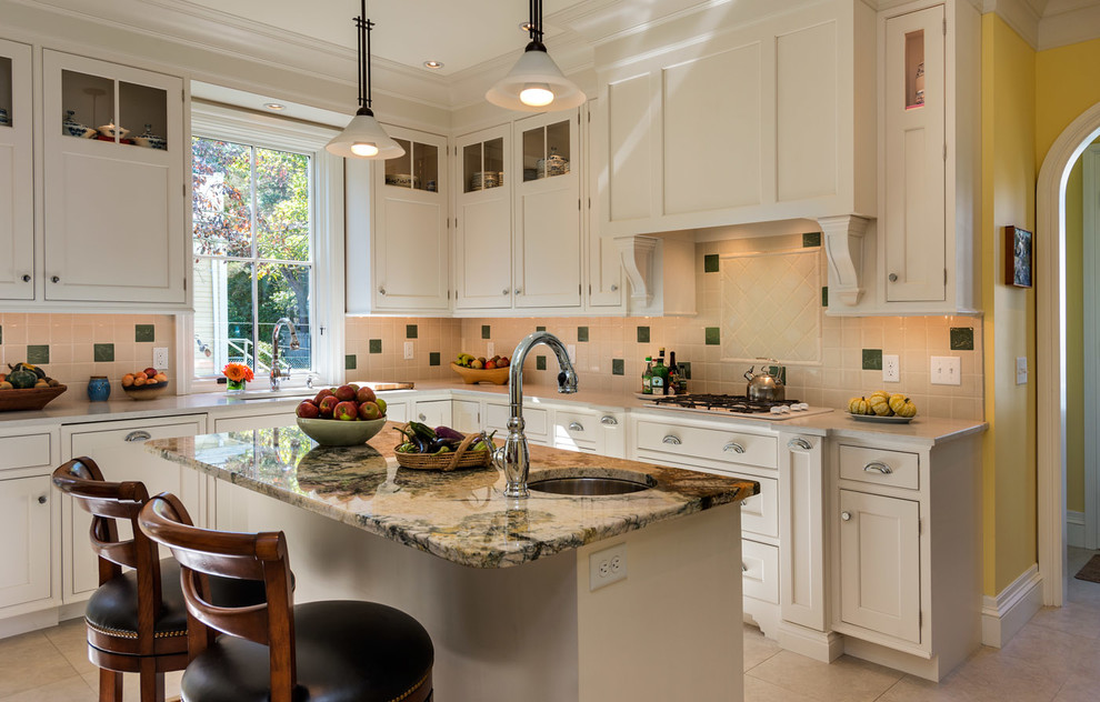 Traditional u-shaped eat-in kitchen in Boston with an undermount sink, granite benchtops, beige splashback, panelled appliances, beaded inset cabinets and white cabinets.