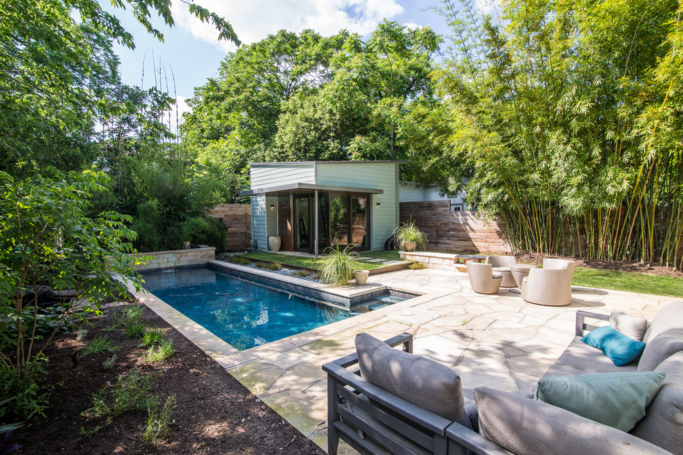 Mid-sized modern backyard partial sun xeriscape in Austin with natural stone pavers.