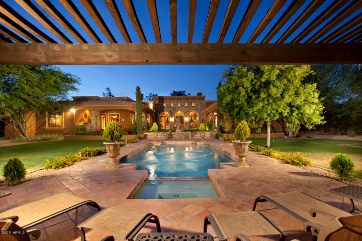 Design ideas for a large mediterranean backyard rectangular natural pool in Phoenix with a pool house.