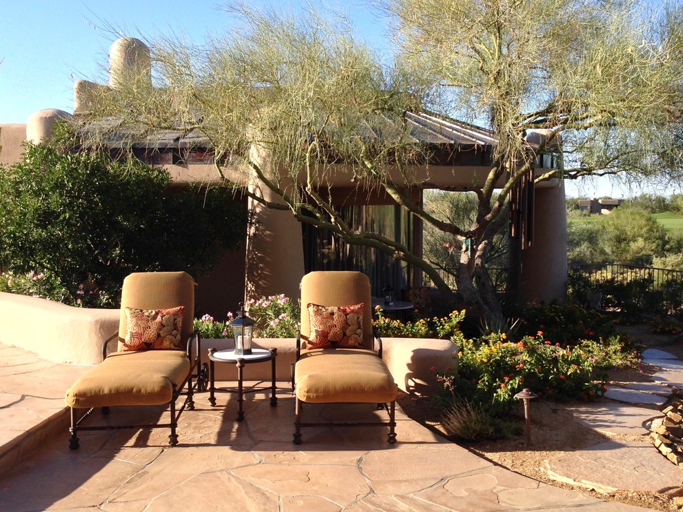 Photo of a mediterranean patio in Phoenix with natural stone pavers and no cover.