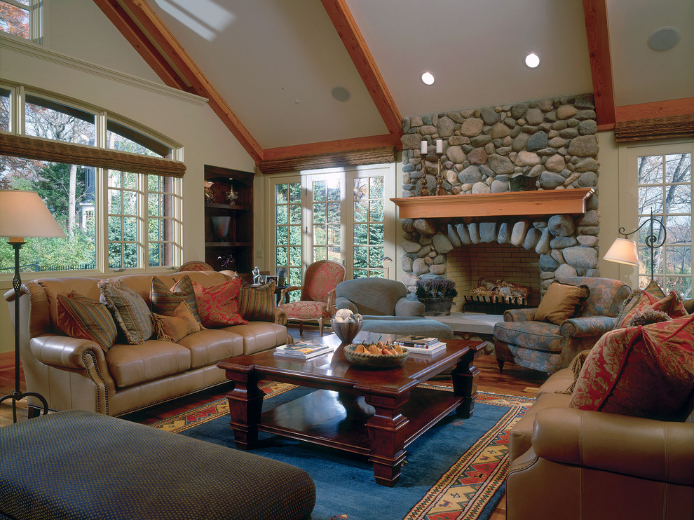 Living Room With Full Stone Fireplace And Vaulted Ceiling