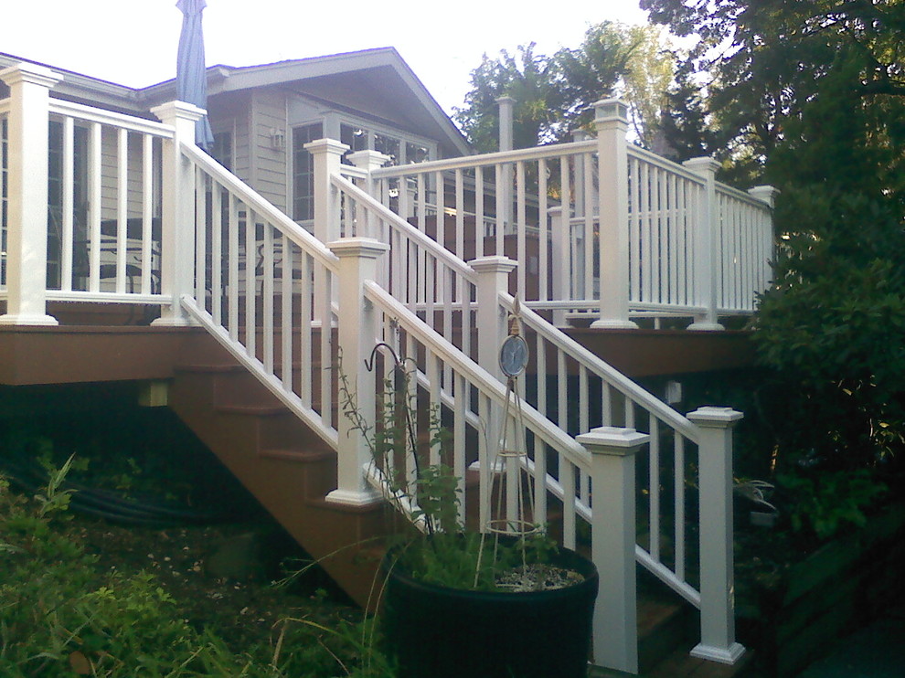 Mid-sized transitional backyard deck photo in New York with no cover
