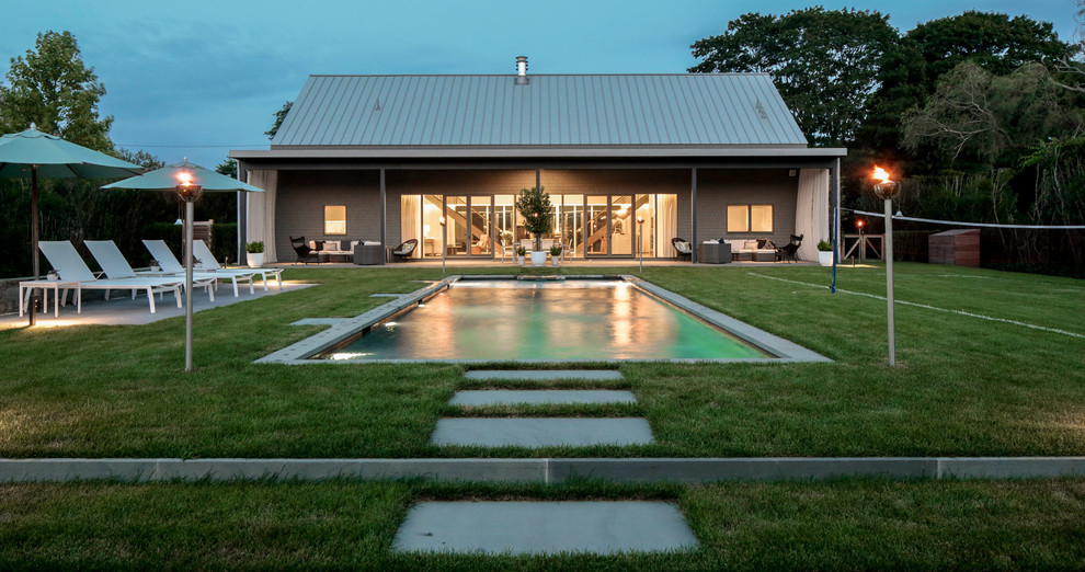 This is an example of a mid-sized contemporary backyard rectangular aboveground pool in New York.