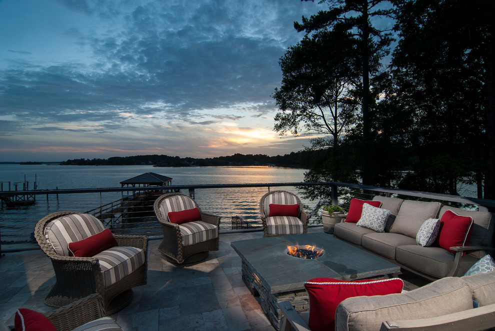 Inspiration for a mid-sized beach style backyard patio in Charlotte with natural stone pavers and no cover.