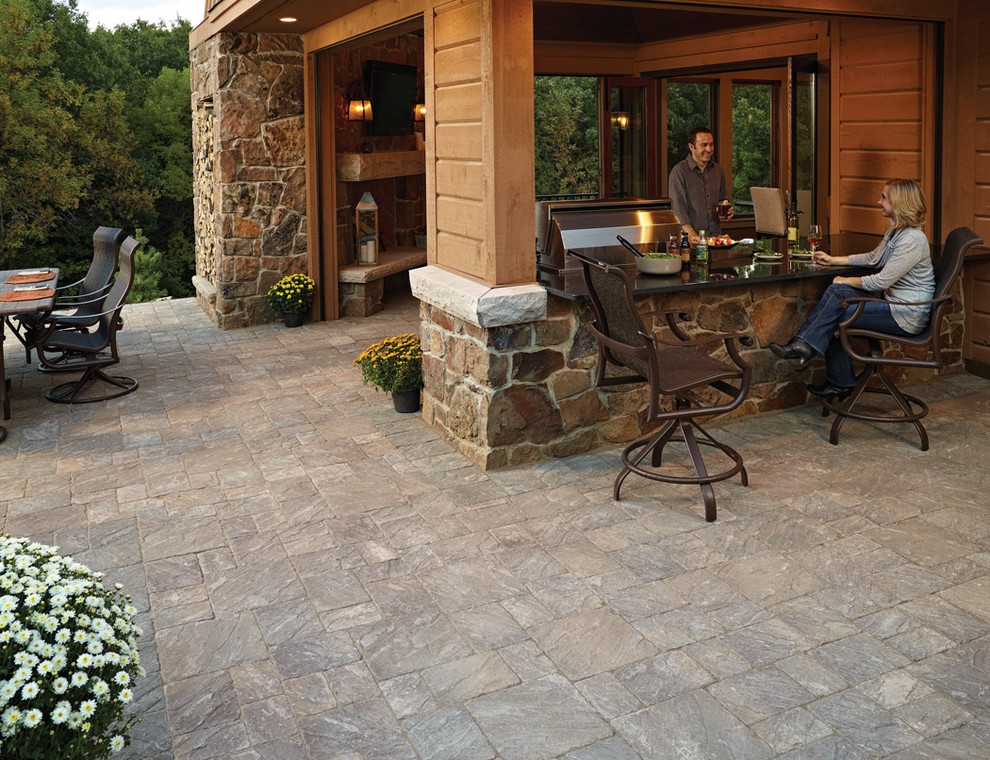 Inspiration for a large country side yard patio in Minneapolis with an outdoor kitchen, concrete pavers and a roof extension.