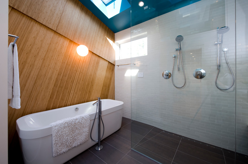 Photo of a contemporary bathroom in DC Metro with a freestanding tub, a double shower, white tile and subway tile.