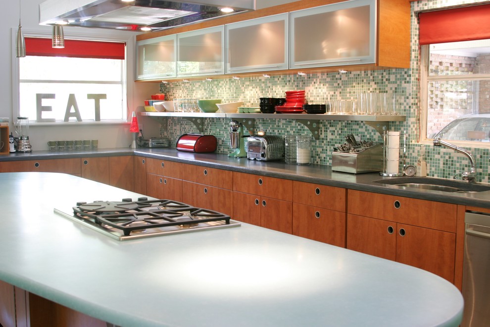 Photo of a midcentury l-shaped open plan kitchen in Dallas with an undermount sink, flat-panel cabinets, medium wood cabinets, concrete benchtops, multi-coloured splashback and stainless steel appliances.