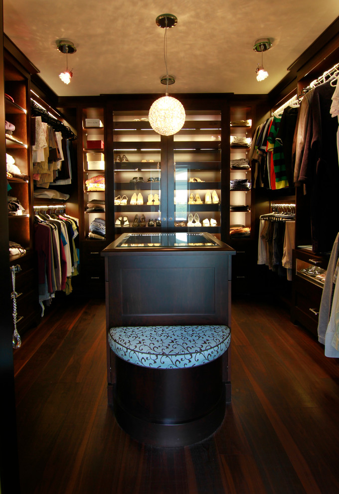 Photo of a mid-sized transitional gender-neutral walk-in wardrobe in Toronto with open cabinets, dark wood cabinets and dark hardwood floors.