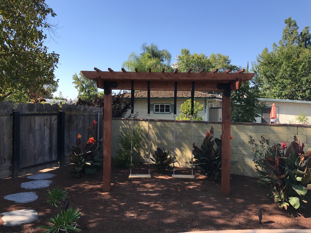 This is an example of a mid-sized shade backyard mulch formal garden.