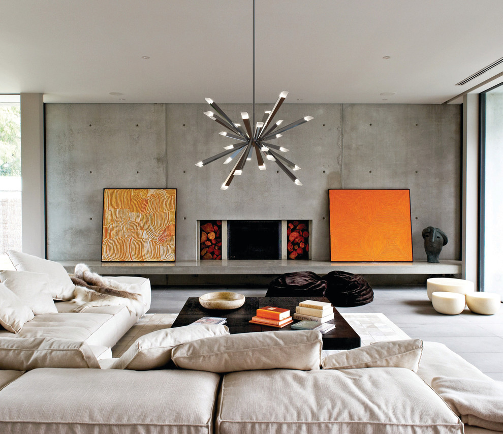 This is an example of a contemporary living room in Montreal with a standard fireplace and a concrete fireplace surround.