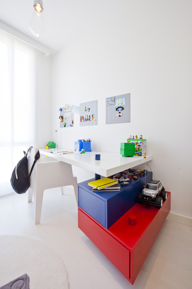 This is an example of a modern kids' study room for kids 4-10 years old and boys in Other with white walls and white floor.