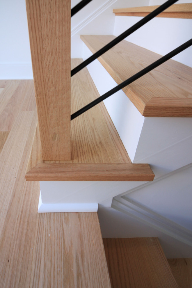 Inspiration for a mid-sized contemporary wood floating staircase in DC Metro with painted wood risers, mixed railing and planked wall panelling.