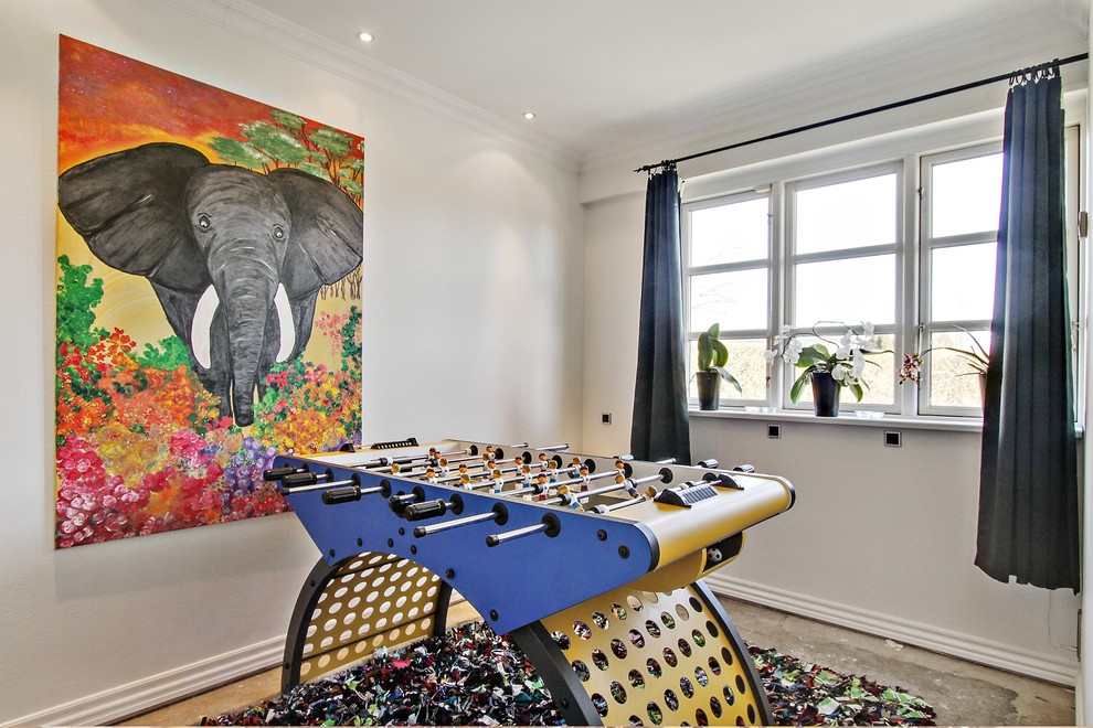 Photo of a mid-sized eclectic enclosed family room in Copenhagen with a game room, concrete floors, no tv, white walls and no fireplace.