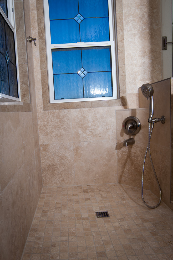 Inspiration for a mid-sized traditional master bathroom in San Diego with flat-panel cabinets, light wood cabinets, a corner shower, a one-piece toilet, beige tile, ceramic tile, brown walls, travertine floors, a drop-in sink and quartzite benchtops.