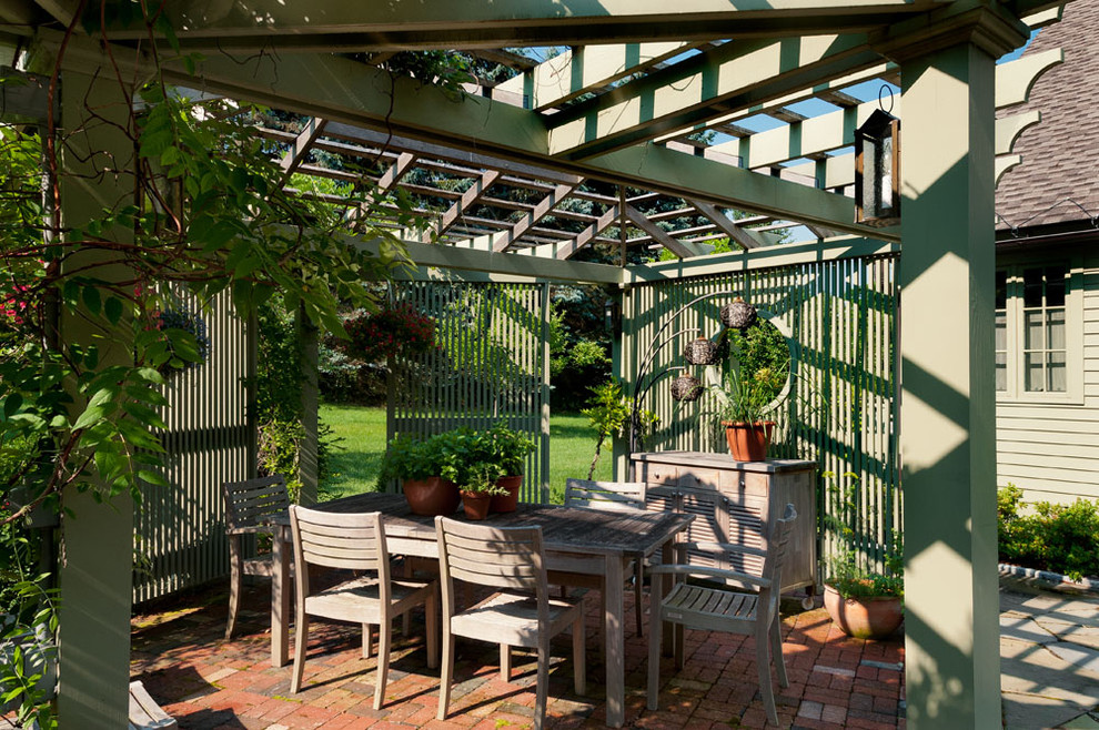 Inspiration for a country courtyard patio in New York with a pergola.