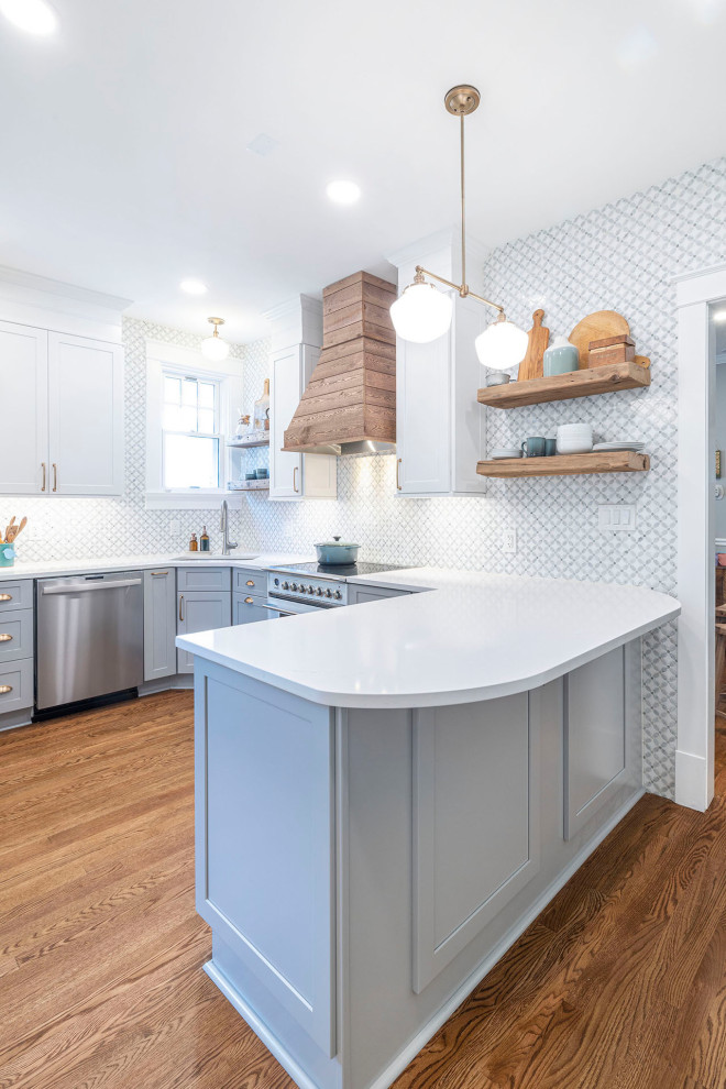 Foto på ett stort lantligt vit kök, med en undermonterad diskho, skåp i shakerstil, grå skåp, bänkskiva i kvarts, grönt stänkskydd, stänkskydd i marmor, vita vitvaror, mellanmörkt trägolv, en halv köksö och brunt golv