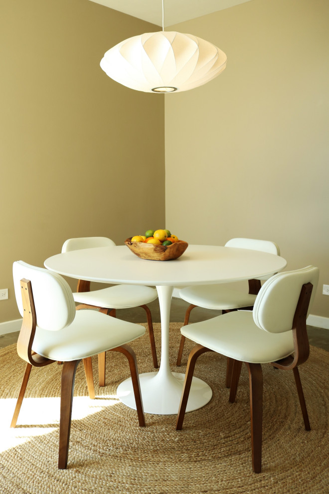 This is an example of a small transitional separate dining room in Phoenix with beige walls, concrete floors and beige floor.