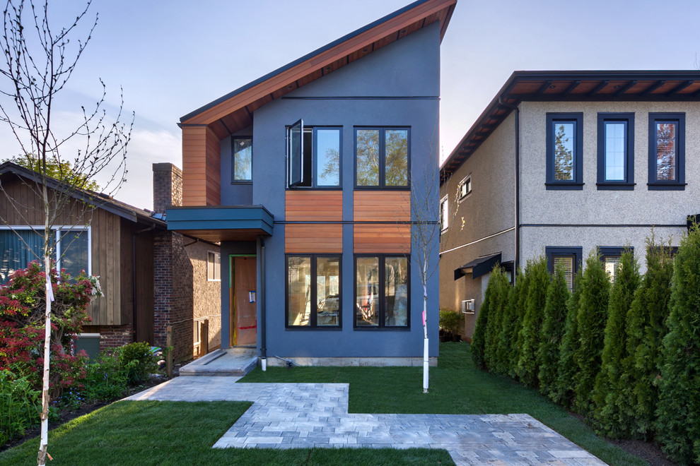 Example of a transitional home design design in Vancouver
