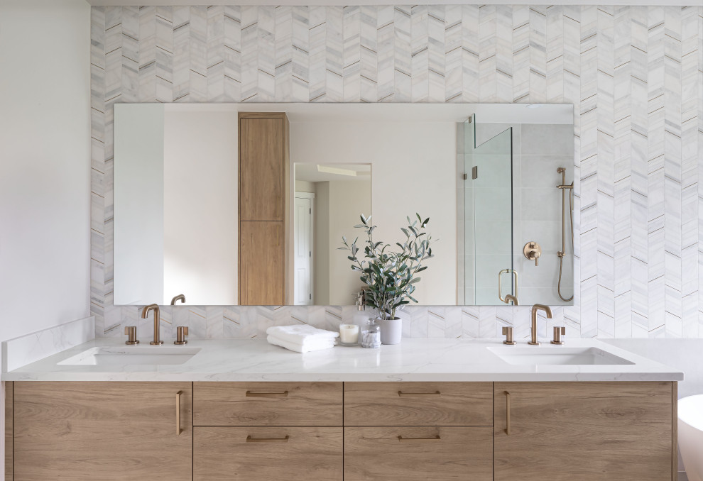 Example of a mid-sized transitional master white tile and marble tile porcelain tile, gray floor and double-sink freestanding bathtub design in Seattle with flat-panel cabinets, light wood cabinets, a two-piece toilet, white walls, an undermount sink, quartz countertops, a hinged shower door, white countertops and a floating vanity