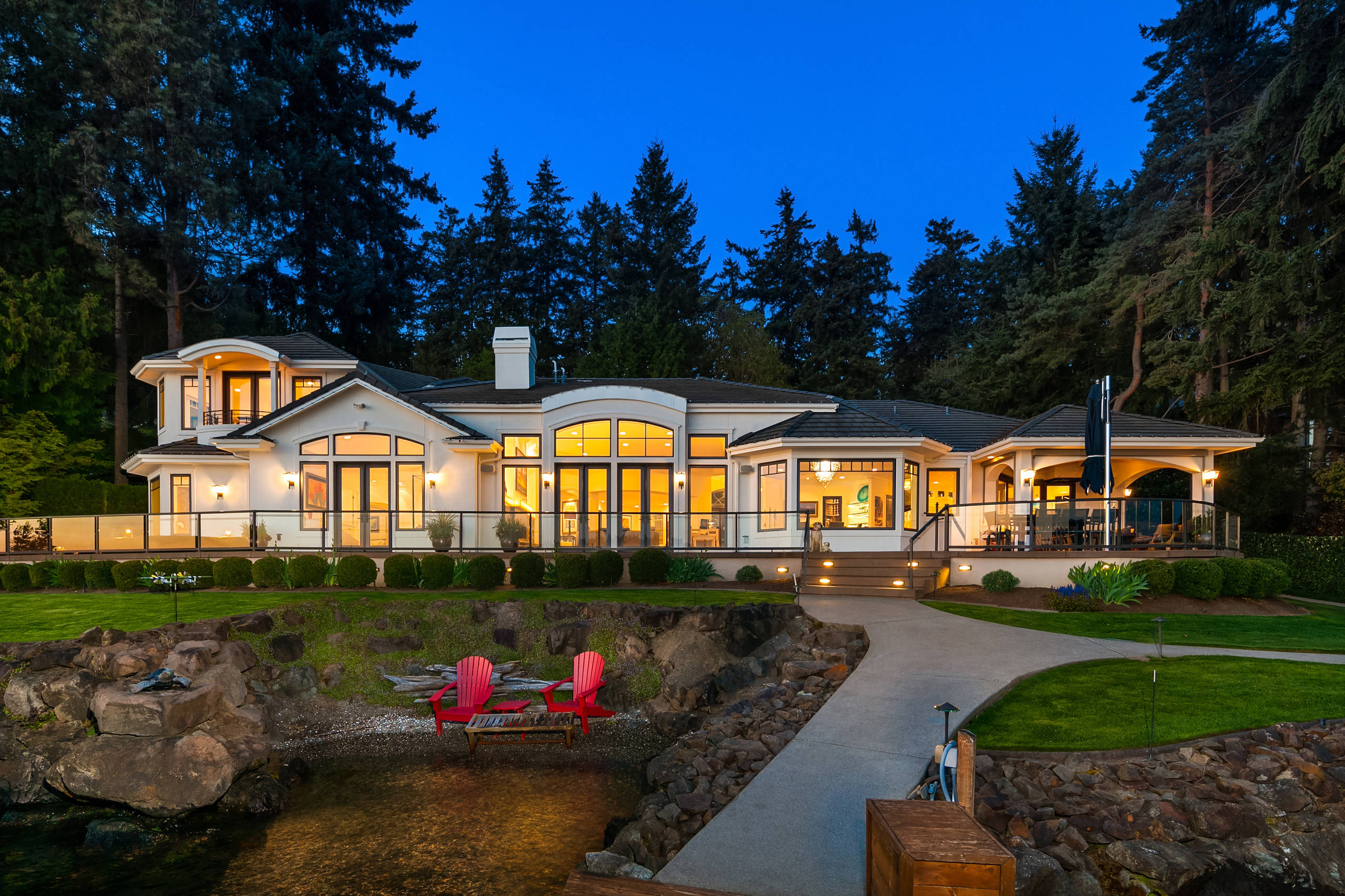 Huge contemporary white two-story stucco house exterior idea in Seattle with a hip roof and a tile roof