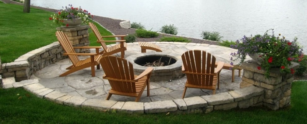 Photo of a traditional backyard patio in New York with a fire feature and natural stone pavers.