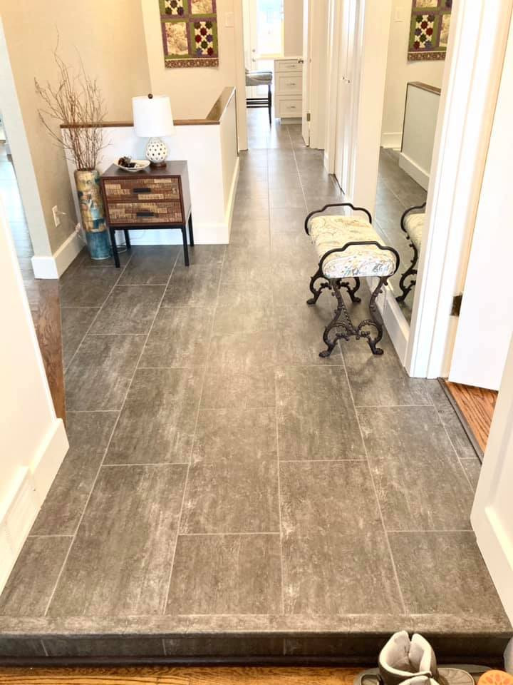 Example of a mid-sized transitional u-shaped vinyl floor and gray floor enclosed kitchen design with an undermount sink, shaker cabinets, beige cabinets, quartz countertops, white backsplash, ceramic backsplash, stainless steel appliances and white countertops